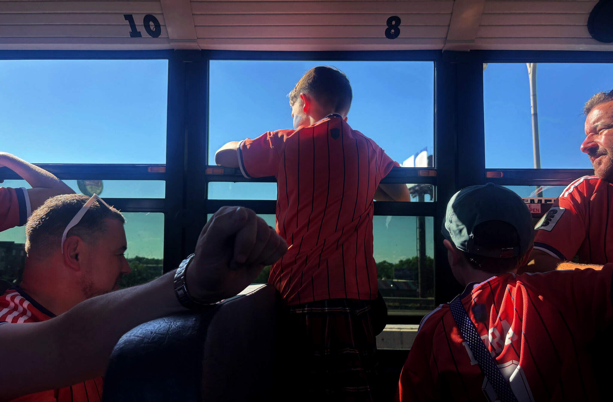 A young fan of Scotland looks out of the window on a chartered school bus headed for Gillette Stadium. (Eve Zuckoff/WBUR)