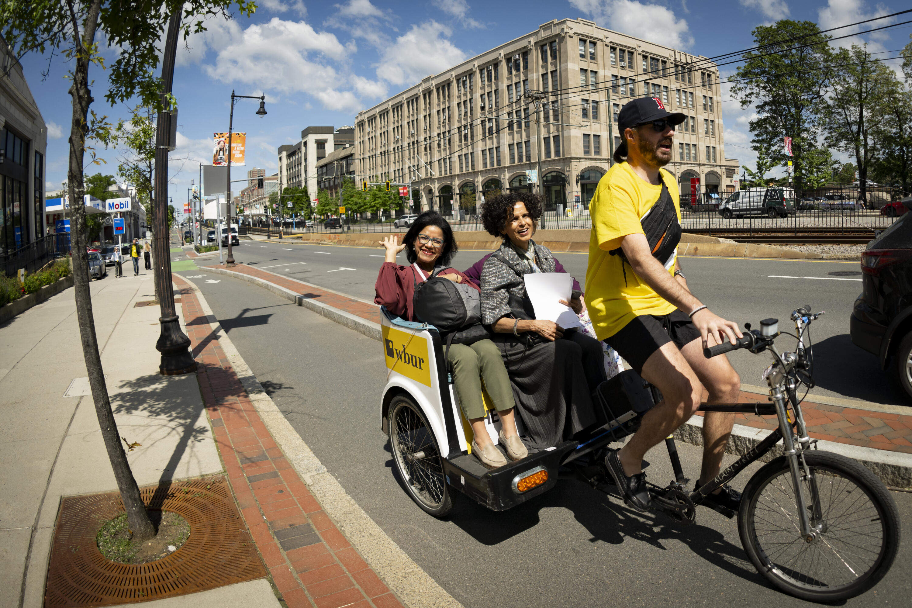 Attendees take a pedi-cab ride down Commonwealth Avenue in Boston to get to sessions at The WBUR Festival on May 29. (Rachel O’Driscoll/Bolt Creative Group for WBUR)