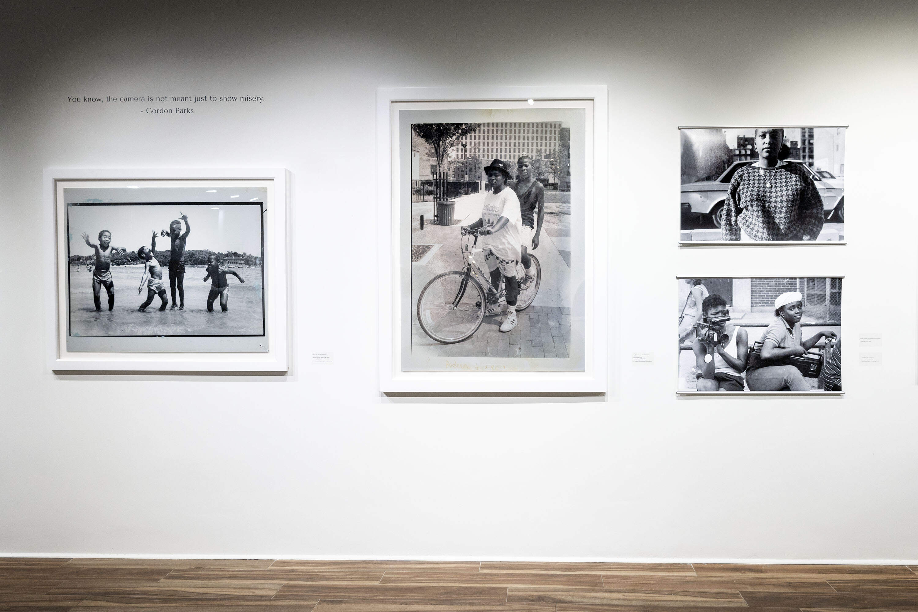 A wall of black and white images at the "A Place Called Home" exhibition at the Street Theory Collective Gallery on Massachusetts Ave. in Cambridge. (Robin Lubbock/WBUR)