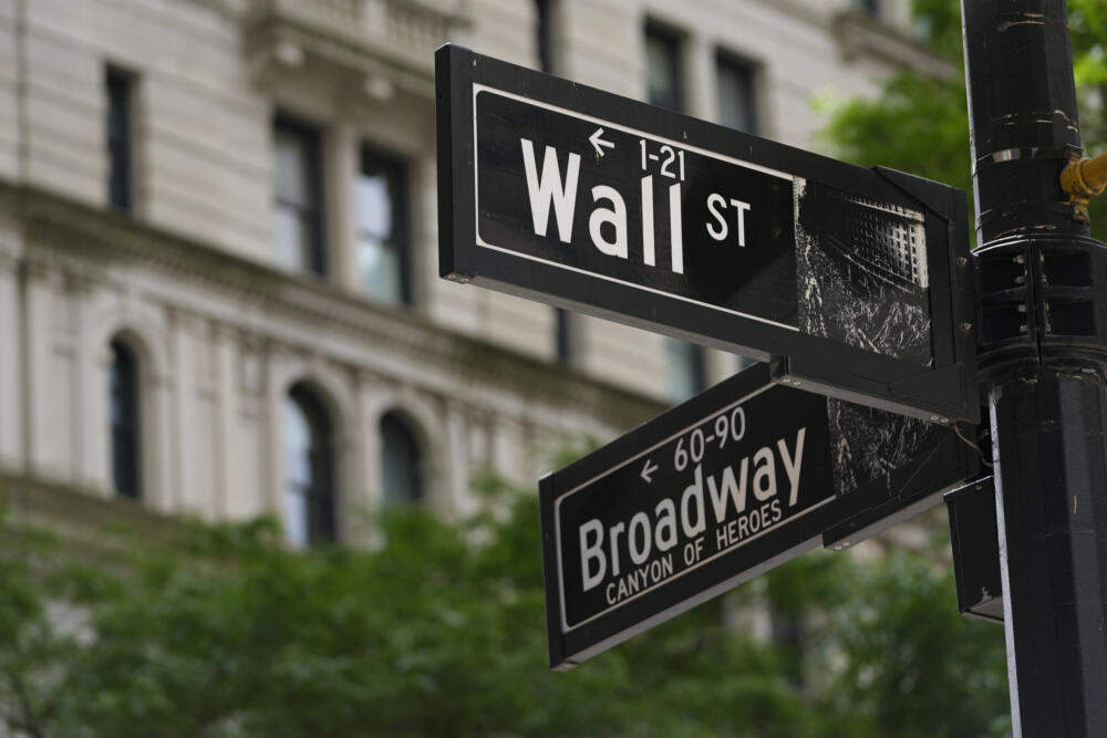 Signs at the intersection of Wall Street and Broadway in New York, June 12, 2024. (Pamela Smith/AP)