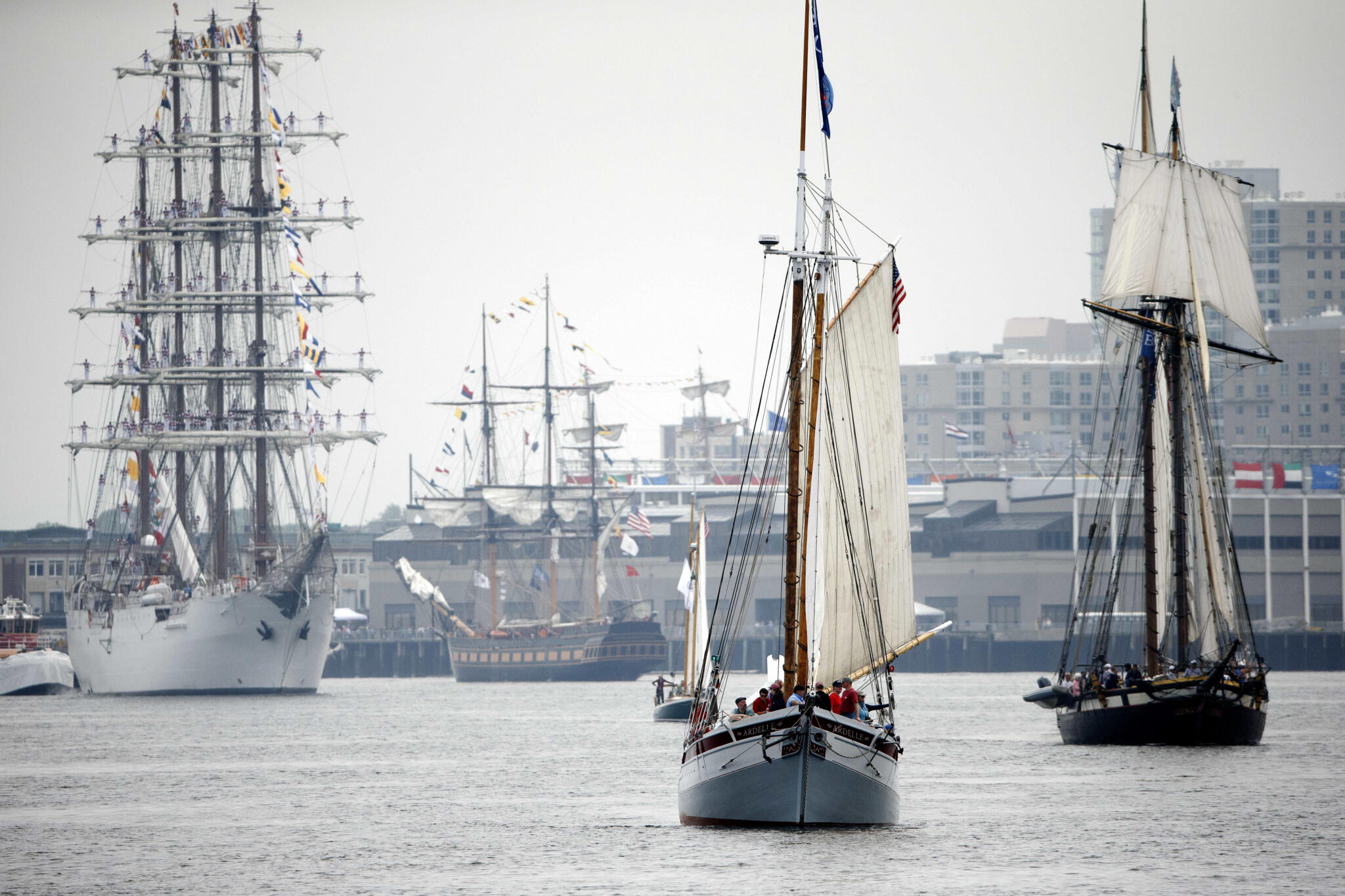 Tall ships moving through Boston during a previous Parade of Sail