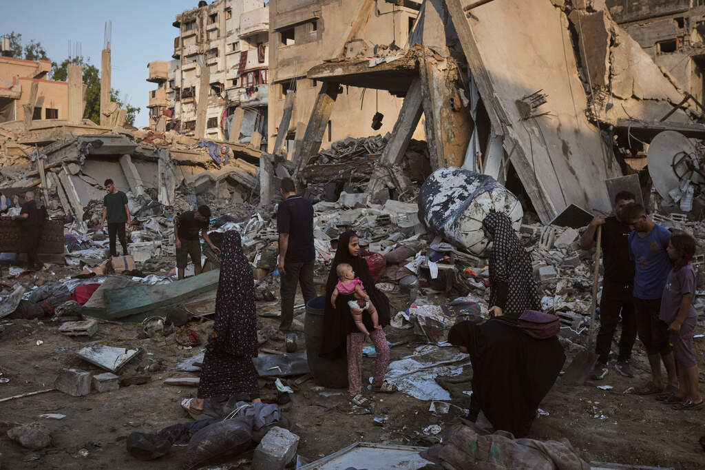 Palestinians salvage their belongings from the rubble of a building and tents destroyed in an Israeli airstrike in Gaza City, Thursday, July 30, 2026. (AP Photo/Jehad Alshrafi)