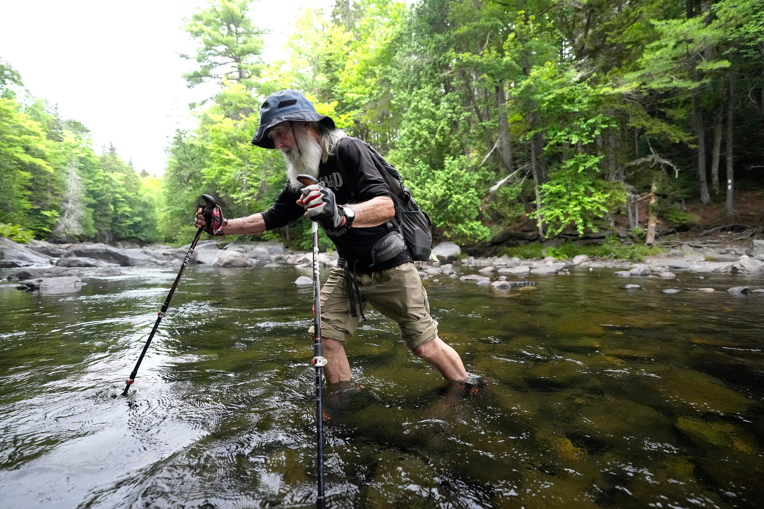 Appalachian Trail hiker Dale Sanders wades across Big Wilson Stream on the 100-Mile Wilderness north of Monson, Maine, Wednesday, July 29, 2026. (Robert F. Bukaty/AP)