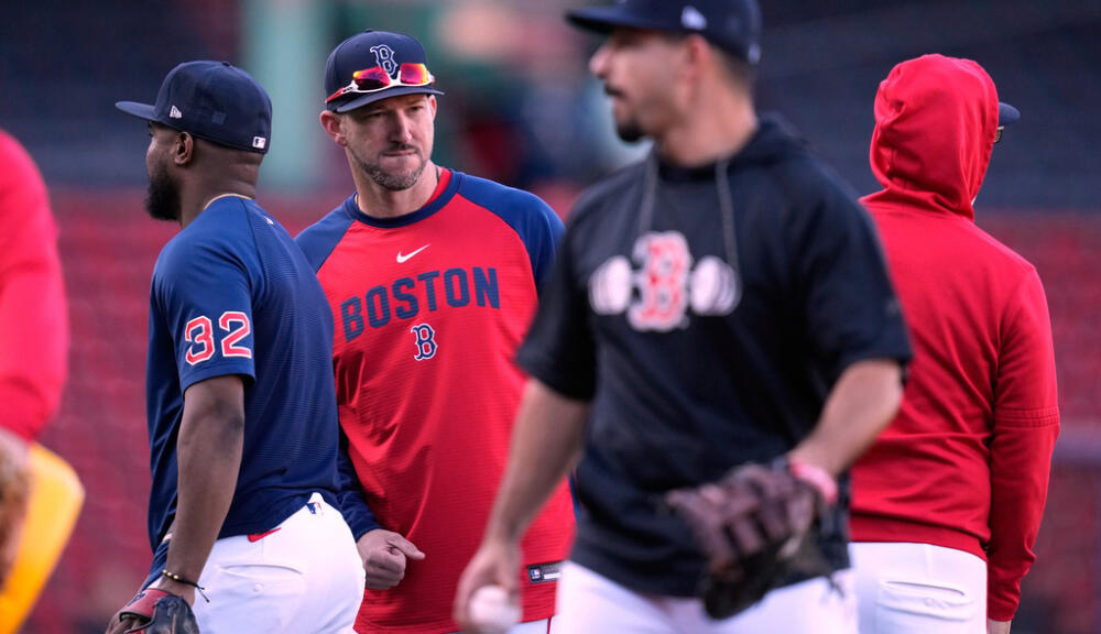 Photo: wbur.org Boston Red Sox manager Chad Tracy talks with his players during batting practice prior to a baseball game against the