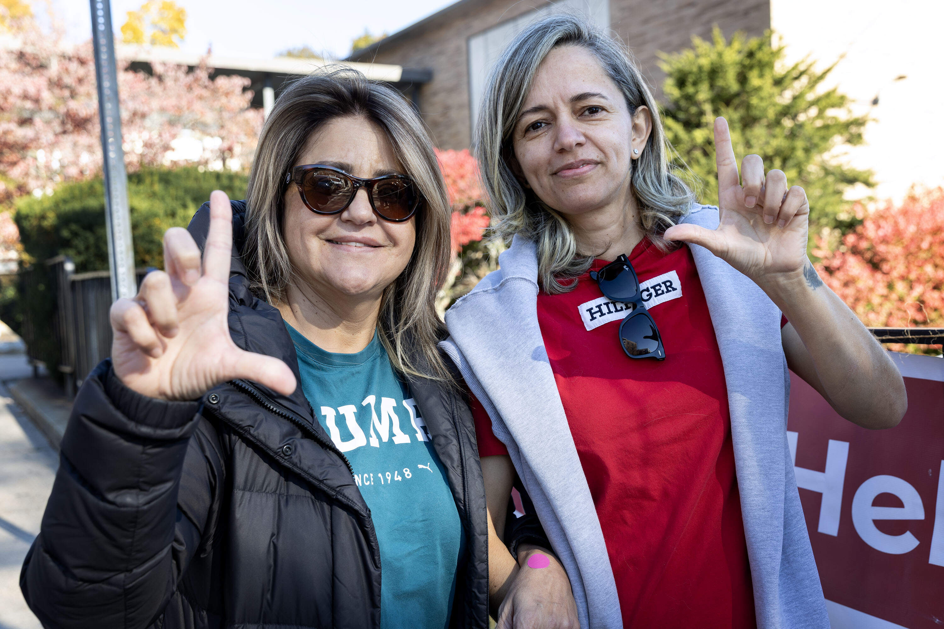 Voters Soraya Braga and Regiane Braga show their support for Lula outside the voting station for the Brazilian election at Salemwood School in Malden, Mass. (Robin Lubbock/WBUR)