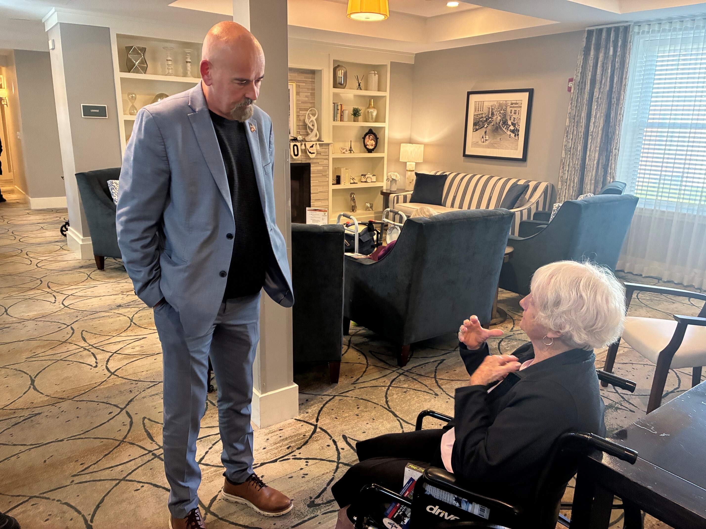 John Deaton, Republican candidate for U.S. Senate, talks with a resident at Forestdale Park in Malden. (Anthony Brooks/WBUR)